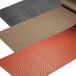 A group of black, brown, and tan rubber floor mats.