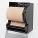 A Lavex Natural Kraft hardwound paper towel roll on a dispenser.