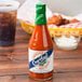 A close up of a Crystal hot sauce bottle on a table.