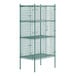 A green wire security cage with four shelves.