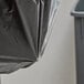 A Lavex Pro black heavy-duty trash bag placed on a trash can.