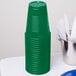 A stack of emerald green plastic cups.