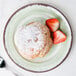 A Carlisle jade melamine bread and butter plate with a pastry and strawberries on it.