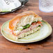 A sandwich on a Carlisle round melamine bread and butter plate.