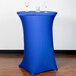 A royal blue Snap Drape Contour table cover on a round bar height table with two glasses on it.