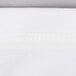 A close up of a white spandex fabric with a small white thread.