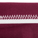 A burgundy Snap Drape spandex table cover with maroon and white stripes.