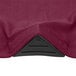 A close up of a red fabric corner on a Snap Drape Contour table cover.