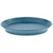 A blue oval deli server with a short base and a rim on a table.