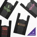 A group of black plastic T-shirt bags with different designs.