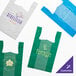 A group of green plastic T-shirt bags.