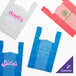 A group of blue plastic t-shirt bags.