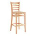 A Lancaster Table & Seating wooden bar stool with a ladder back and natural wood seat.