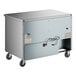 A stainless steel True undercounter freezer on wheels.
