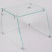 A clear glass table with metal corners on a metal base with the Excellence Straight Glass Sneeze Guard installed.