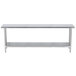 A long stainless steel work table with a stainless steel undershelf.