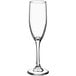 A clear wine glass with a long stem.