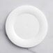 A white Visions plastic plate with a wavy design.
