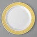 A white plate with yellow lattice design on the rim.