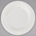 A white Visions plastic plate with swirls on it.