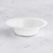 A white Visions plastic bowl with a wavy design on the edge.