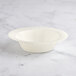 A white Visions plastic bowl with a curved edge on a marble surface.