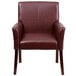 A Flash Furniture burgundy leather reception chair with mahogany legs.