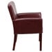 A Flash Furniture burgundy leather reception chair with mahogany legs.