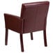 A burgundy leather Flash Furniture reception chair with mahogany legs.