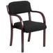 A Flash Furniture black fabric side chair with mahogany wood legs and a black cushion.