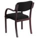 A Flash Furniture black fabric side chair with mahogany wood frame.