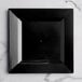 A Visions Florence black square plastic plate on a marble surface.