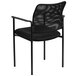 A Flash Furniture black mesh side chair with arms.