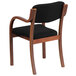 A Flash Furniture black fabric side chair with wooden arms and legs.