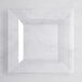 A clear square plate on a white surface.