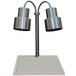 A Hanson Heat Lamps stainless steel carving station with two heat lamps over a white surface.