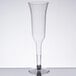 A clear plastic champagne flute on a table.