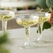 Three Visions clear plastic champagne glasses on a table.