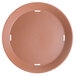 A brown round plastic basket with holes in it.