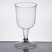 A Visions clear plastic wine goblet with a long stem and base.