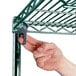 A hand using screws to attach a Metro Super Erecta wire shelf to another shelf.