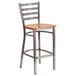 A Flash Furniture metal restaurant barstool with a natural wood seat and ladder back.