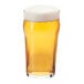 A close-up of a Libbey English Pub glass of beer with foam.