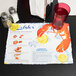 A Hoffmaster lobster design paper placemat with a lemon slice on it.