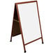 A cherry wood A-frame sign board with white marker board inserts.