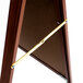 A cherry wood A-frame sign board with a white marker board.
