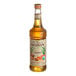 A bottle of Monin Organic Caramel Flavoring Syrup with a label.