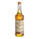 A bottle of Monin Organic Caramel Flavoring Syrup with a label.