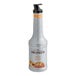 A bottle of Monin Peach Fruit Puree on a white background.