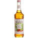 A bottle of Monin Premium Roasted Hazelnut Flavoring Syrup with a label.